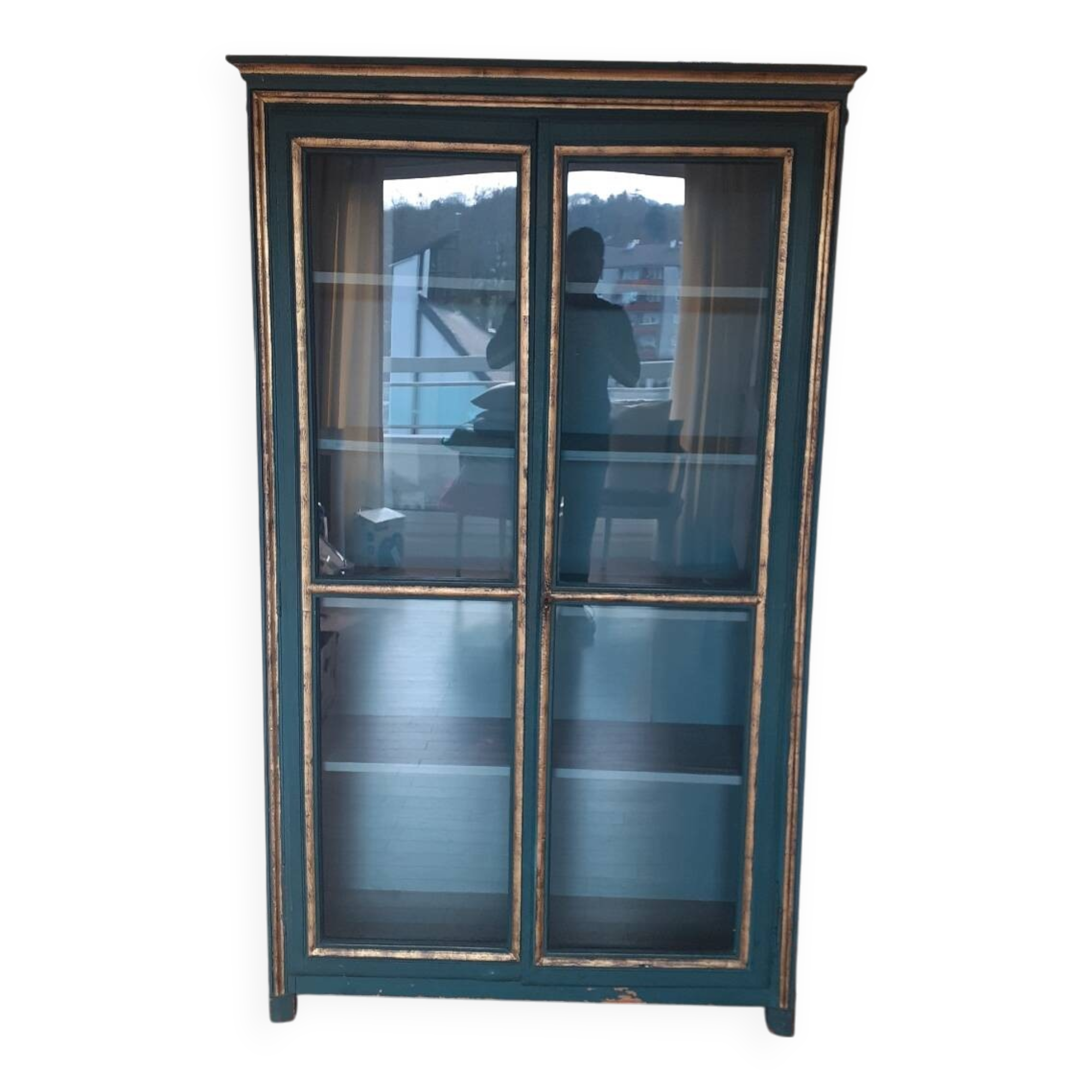 Glass-fronted cabinet in weathered green wood