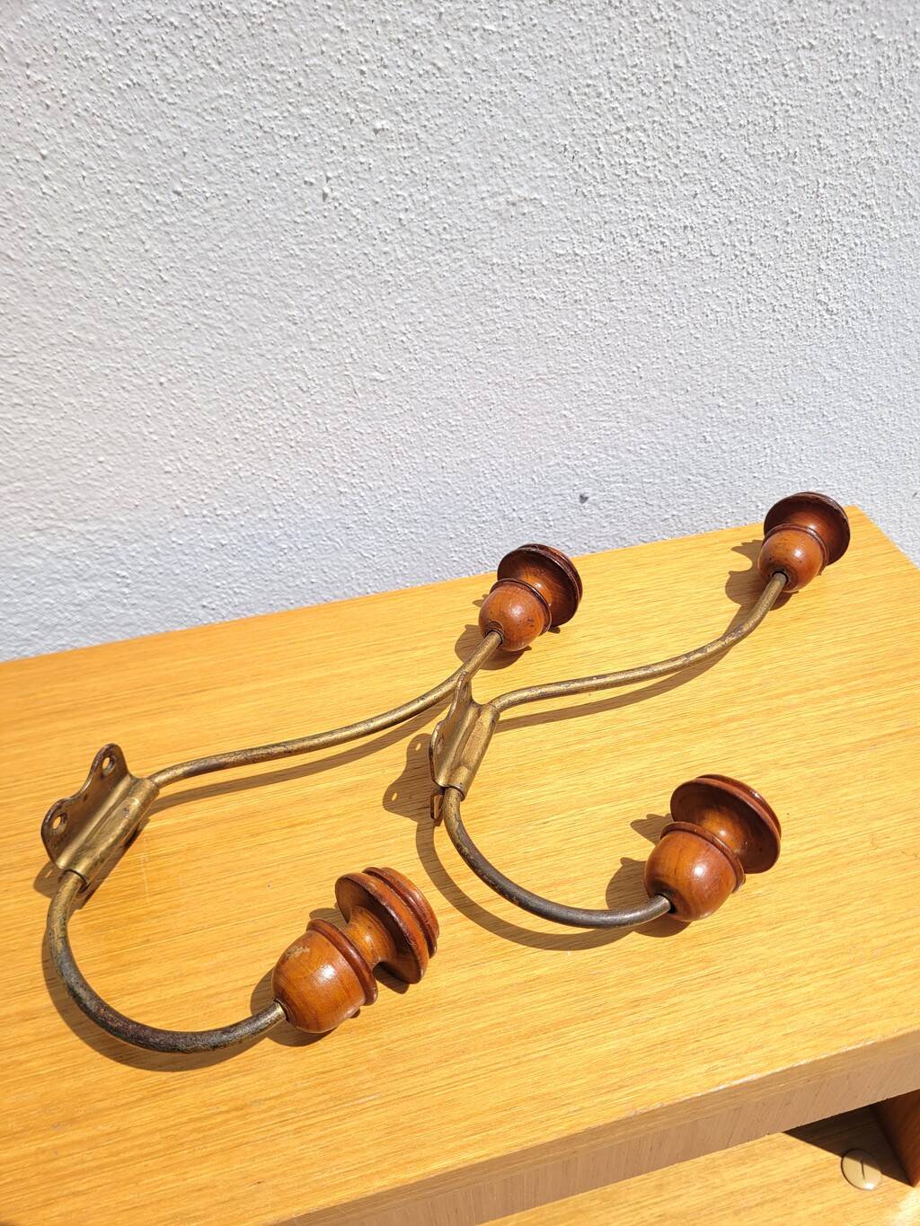 Pair of antique wooden and metal coat hooks