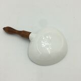 Ceramic aperitif dish and wooden handle.