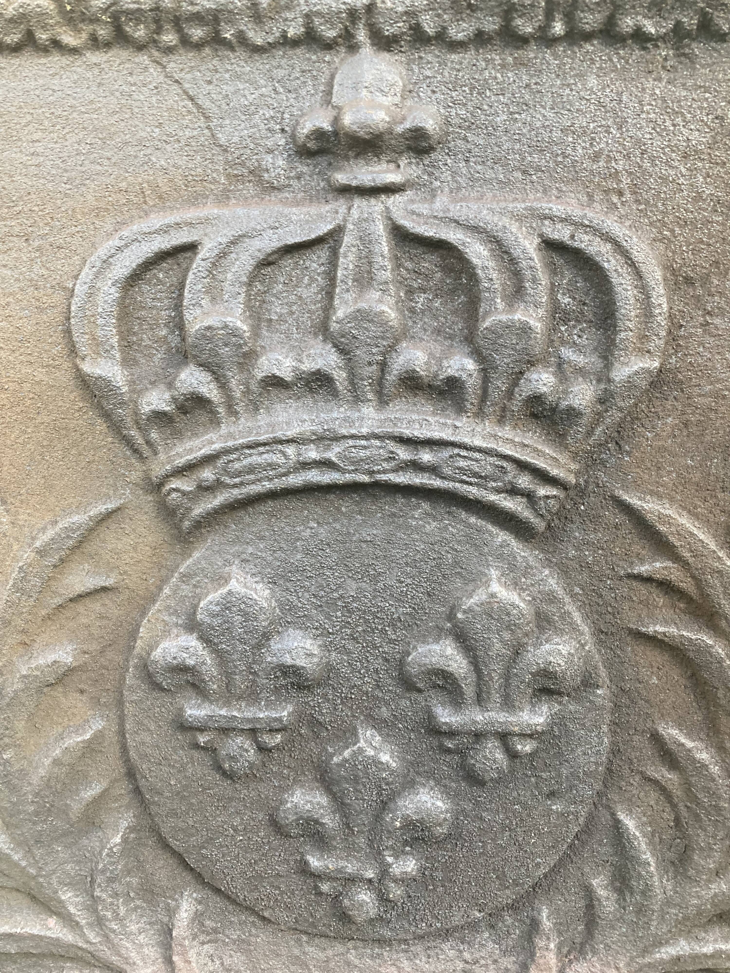 Old cast iron fireback with royal coat of arms