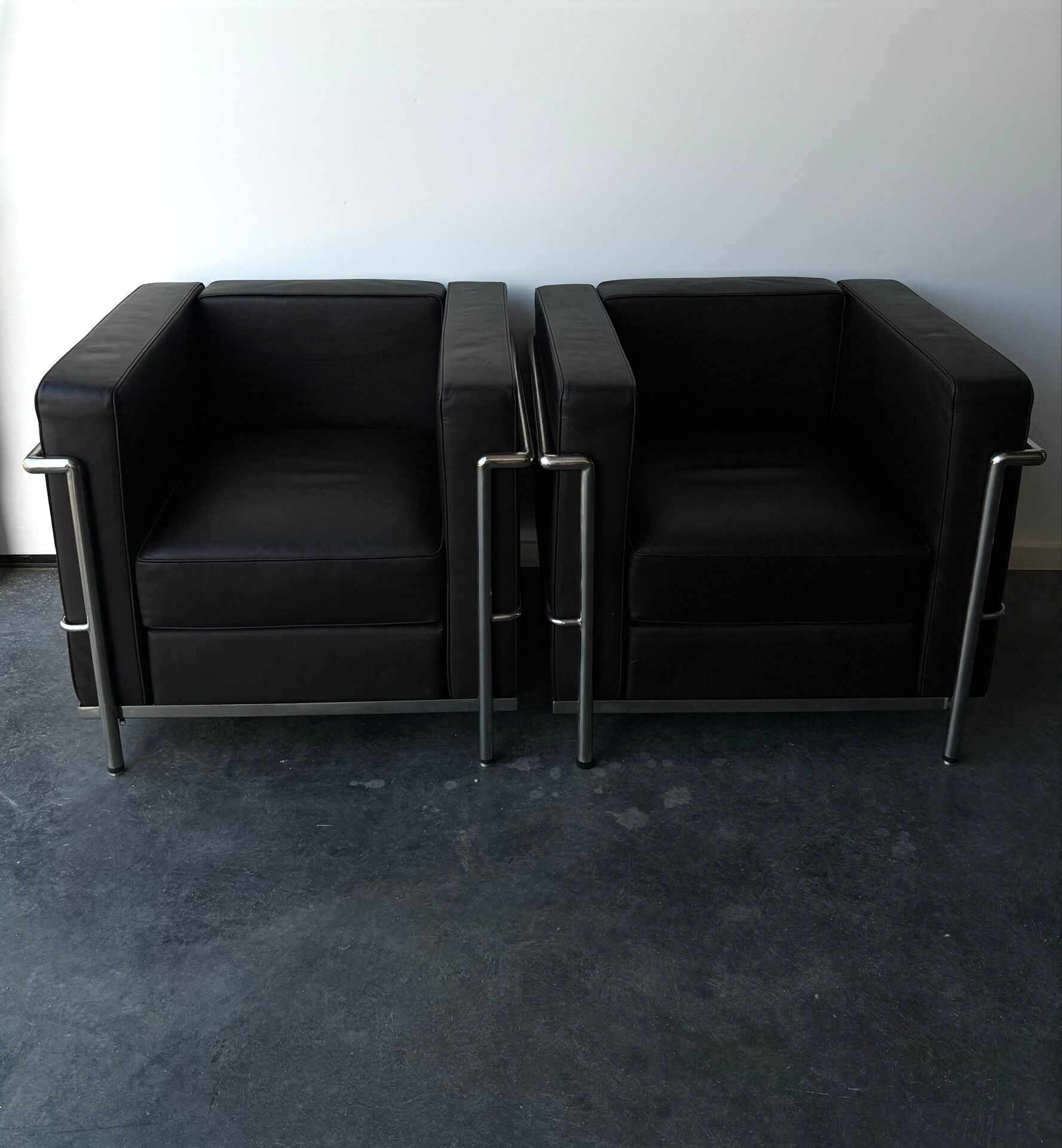 Pair of modernist brown leather armchairs