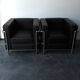 Pair of modernist brown leather armchairs