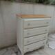 Vintage commode enhanced in beige, wooden top.