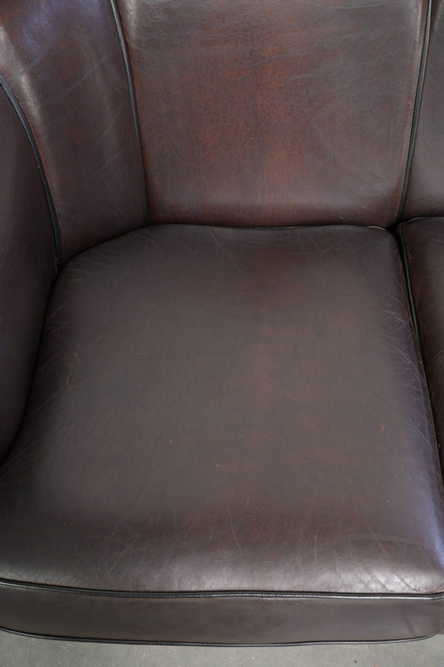 Set of a sheepskin sofa together with its matching club armchair