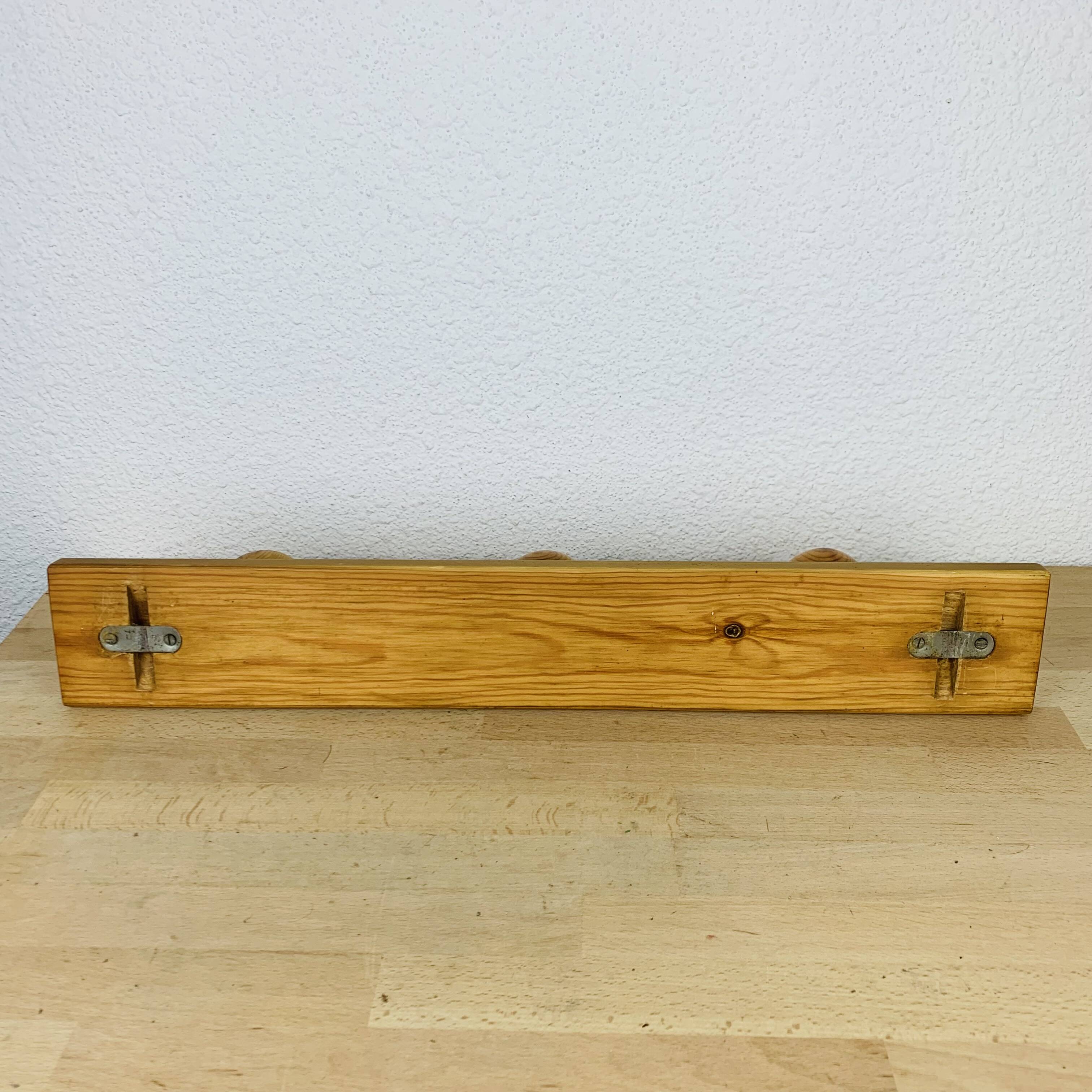Wall coat rack with pine ball hook