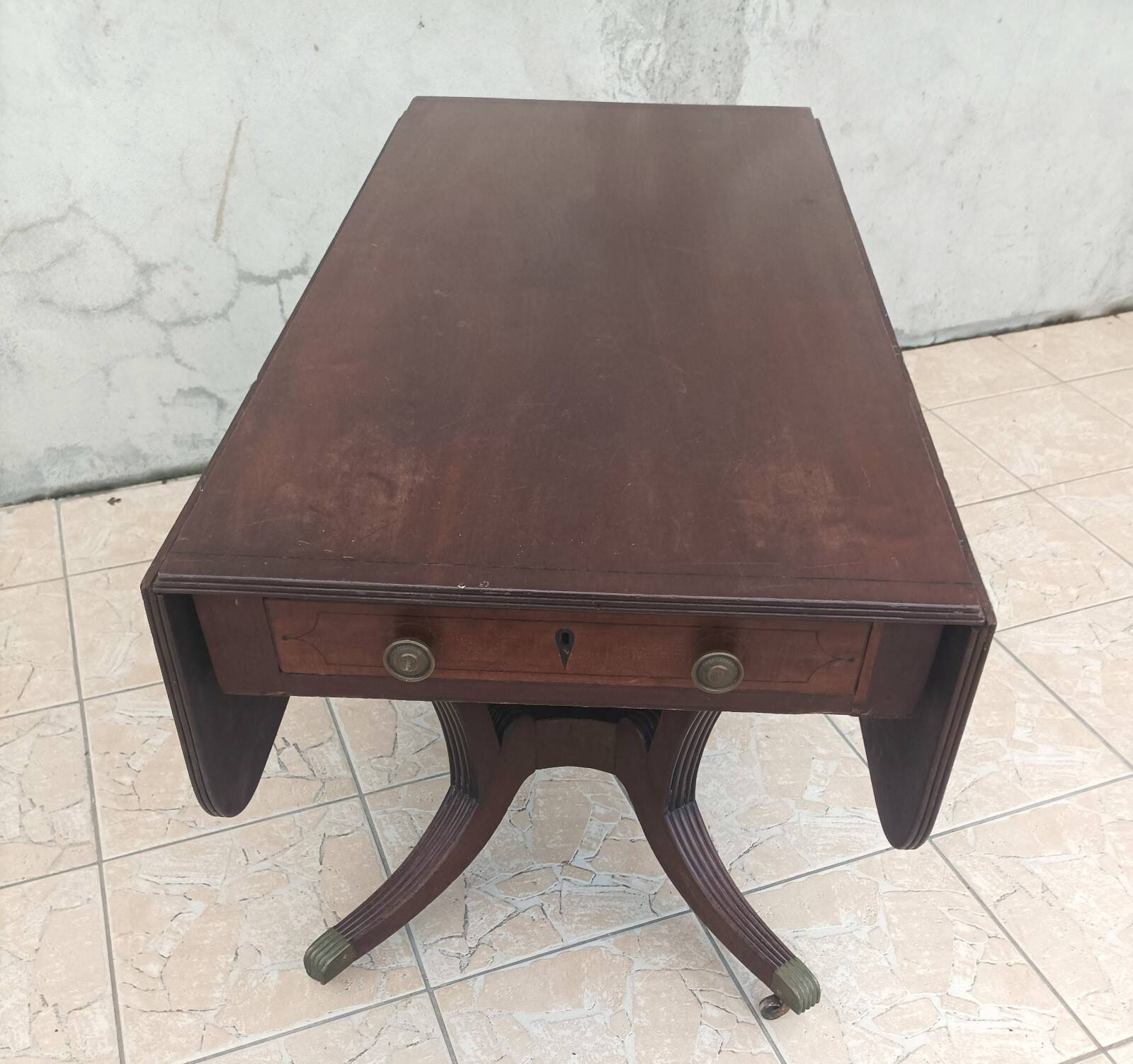 19th-century English style mahogany drop-leaf table.