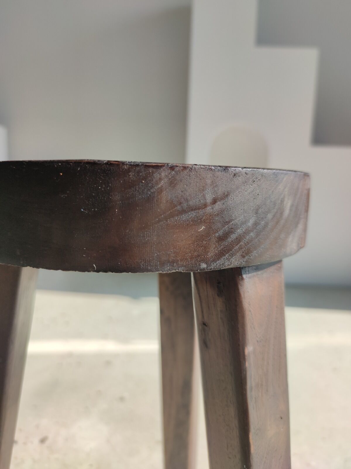 Small high tripod stool in brown solid wood