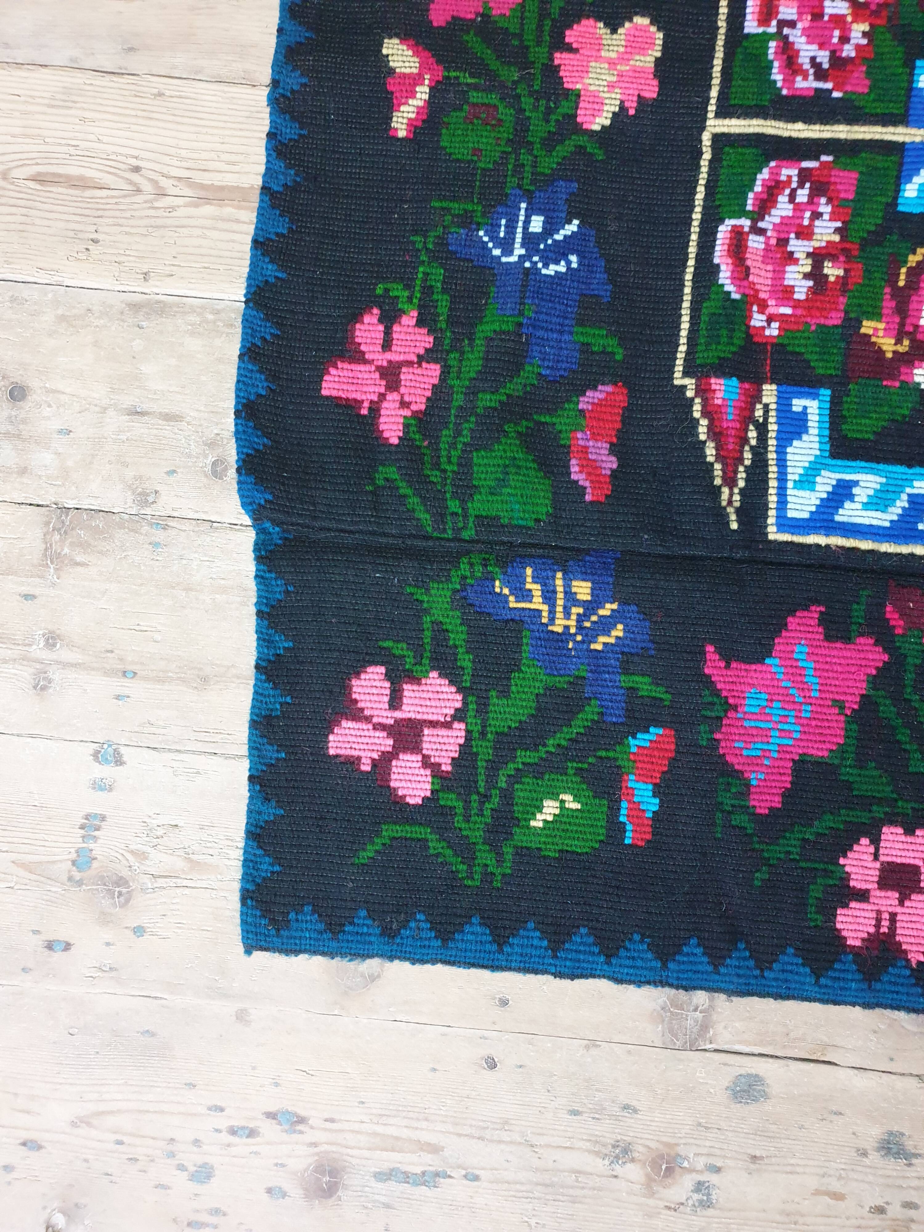 Handwoven floral wool rug, black background with pink roses and geometric design 207x144cm