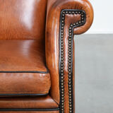 Wingback chair made of sheep leather with black piping in good condition