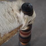 Vintage African artisanal stool, triangular shape with 3 legs, cowhide, 20th century.