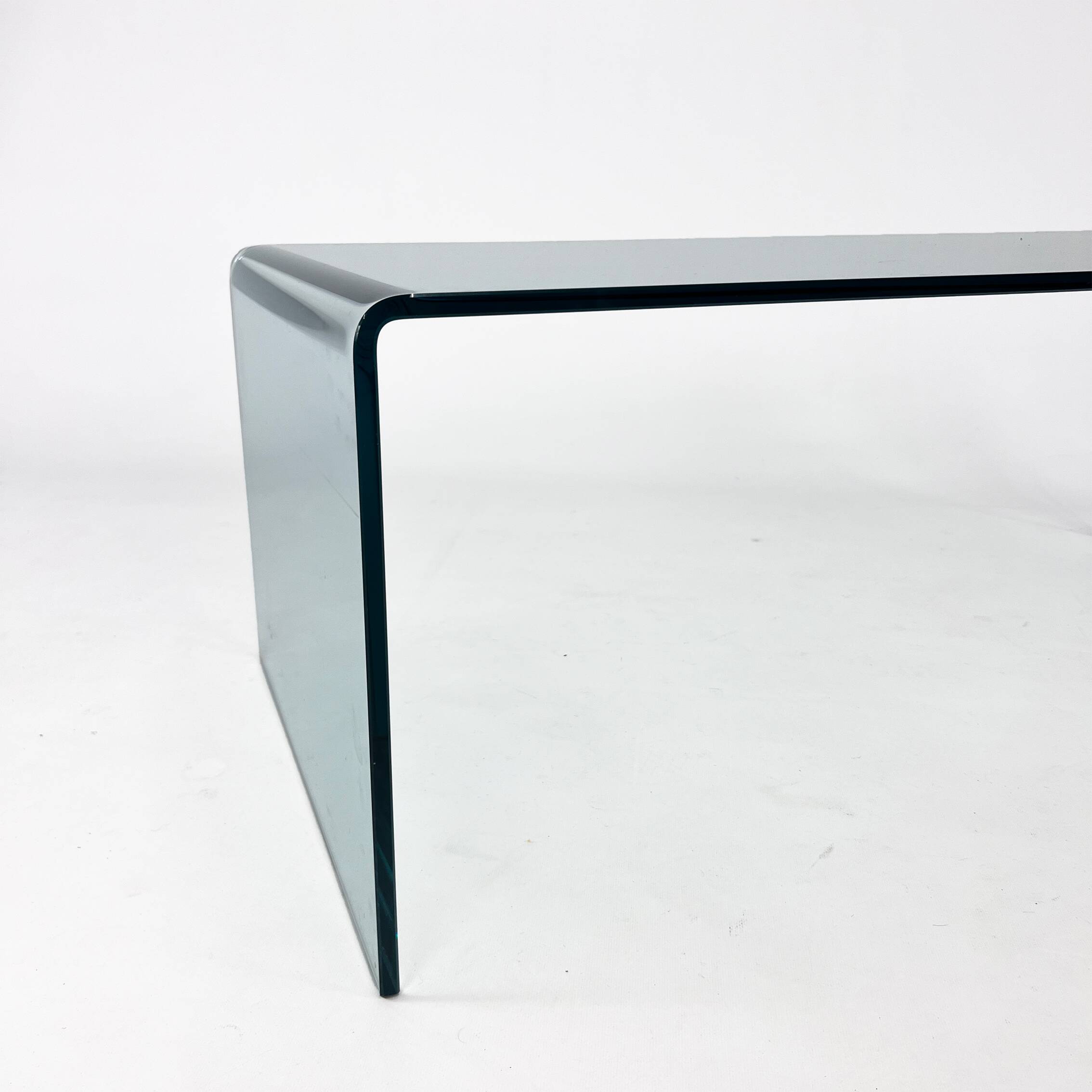 Postmodern coffee table made entirely of glass. Modernist and bitches minimalist look.