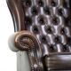 Chesterfield wing chair in dark brown leather with a luxurious appearance