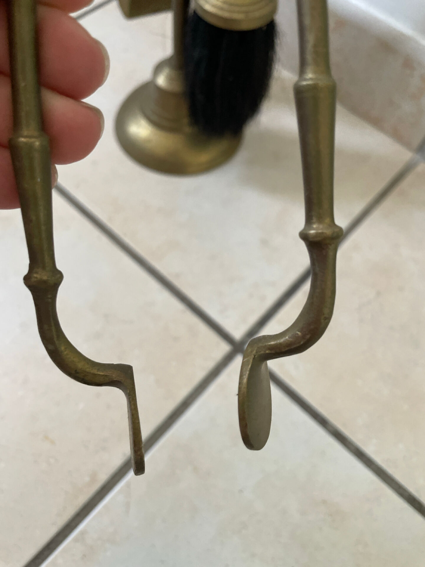 Vintage brass fireplace tool set with shell decoration.