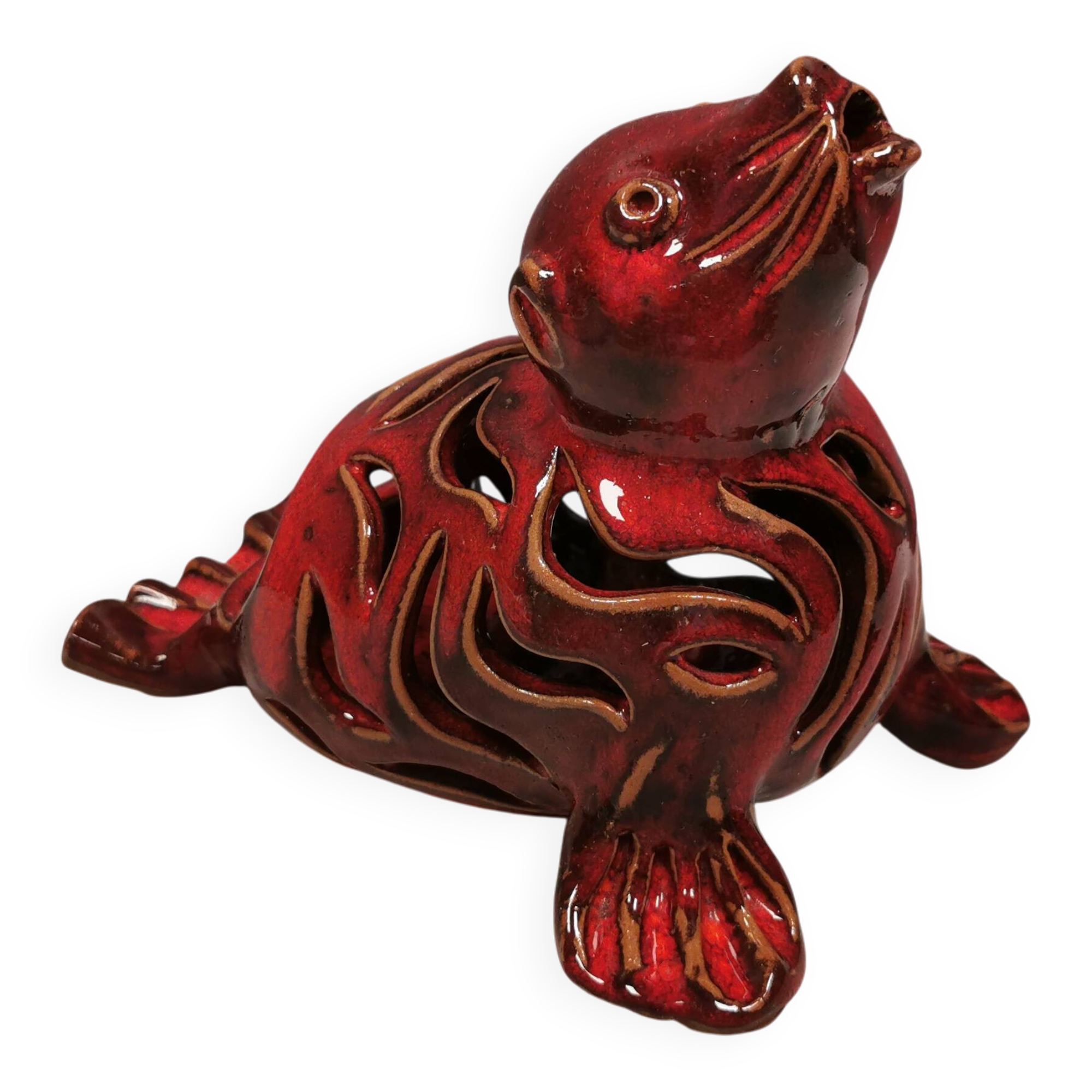 Beautiful seal in ceramic with metallic red glaze.