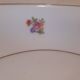 Hexagonal plate Lamotte with a double gold border, decorated with small bouquets.