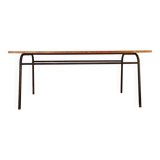 Table with tubular metal legs and wooden top.