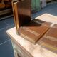 Wooden trompe-l'œil bookends with a book and box