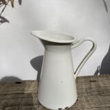 Old white enamelled metal pitcher