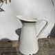 Old white enamelled metal pitcher