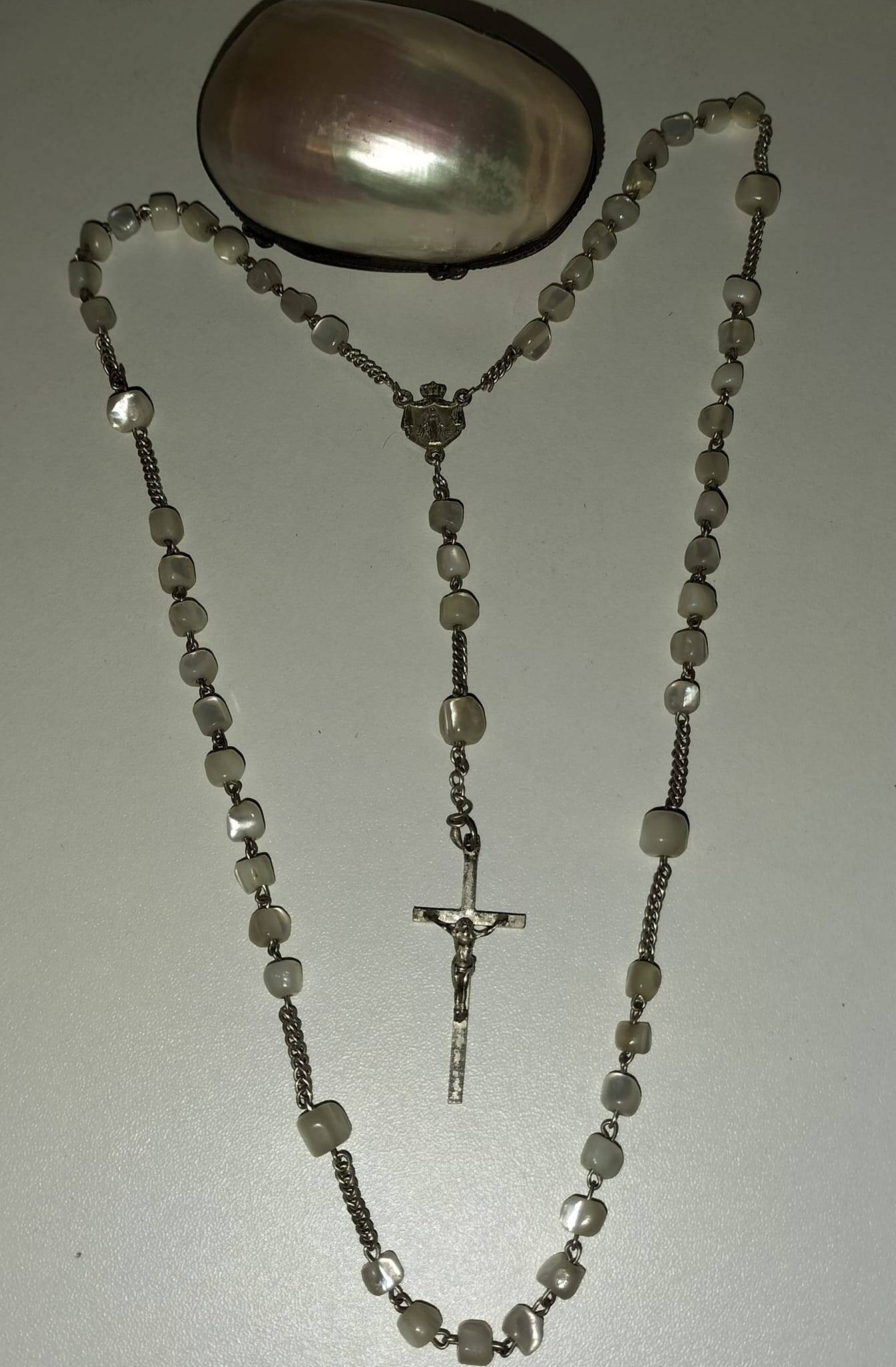 Old mother-of-pearl rosary in its egg box