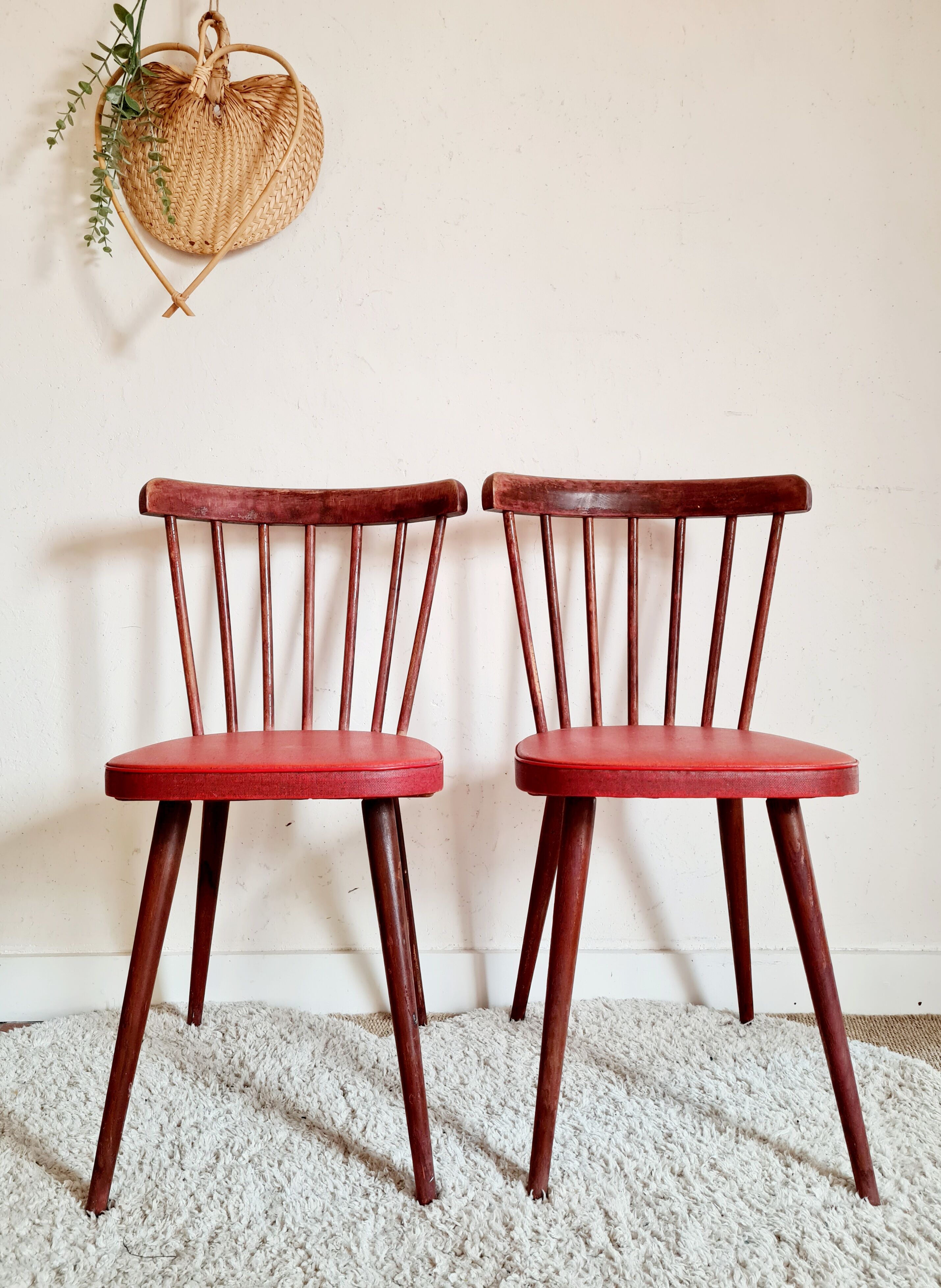 Pair of wooden bistro chairs and red imitation seating
