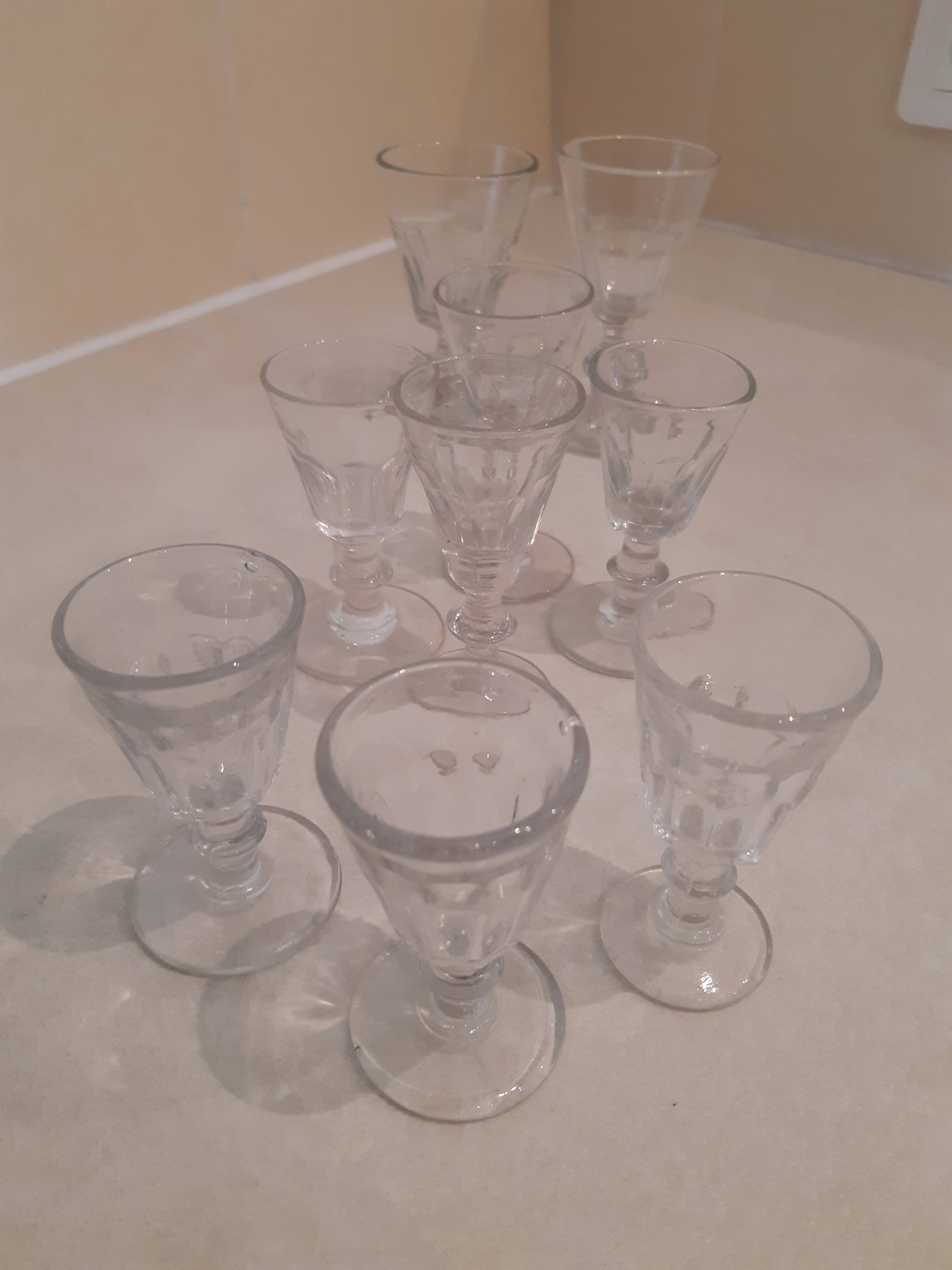 Set of 9 small cut glass stemmed glasses from the 1930s, in various sizes.