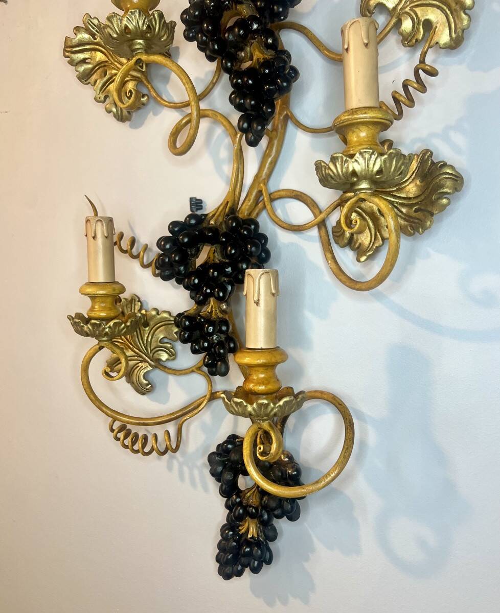 Large pair of wall sconces with vine decorations.