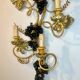 Large pair of wall sconces with vine decorations.