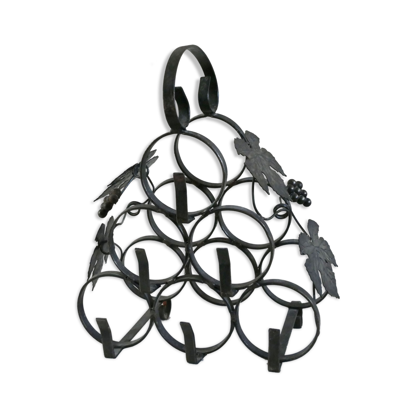Vintage black wrought iron bottle holder decorated with vine leaves
