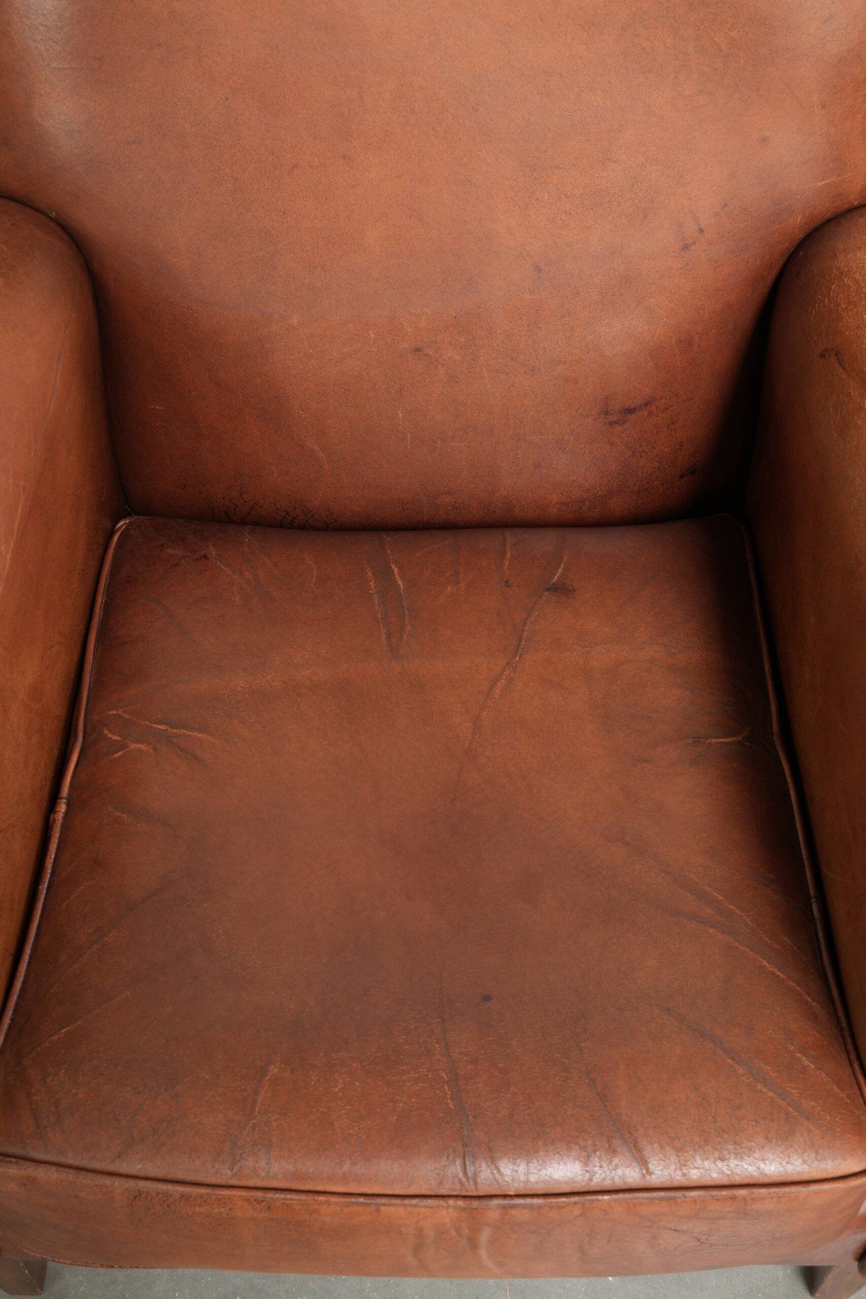 Sturdy vintage sheepskin armchair with a beautiful cognac colour