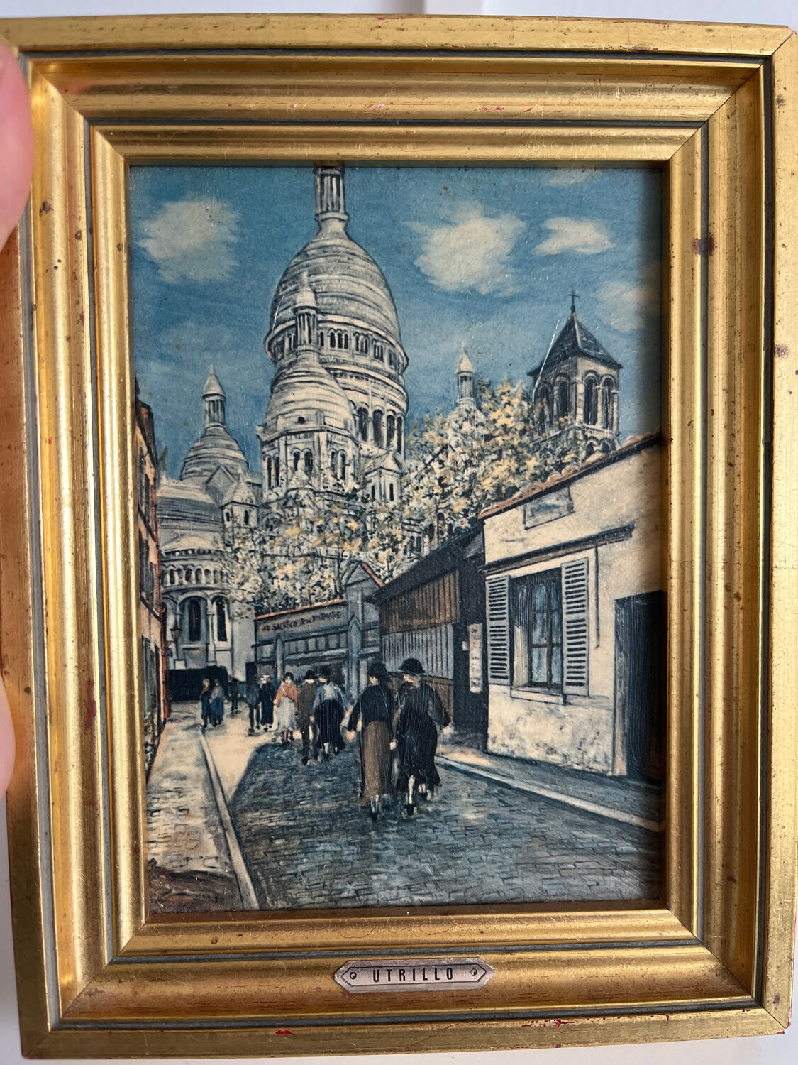 Reproduction of a painting of a walk in the city center by Maurice Trillon