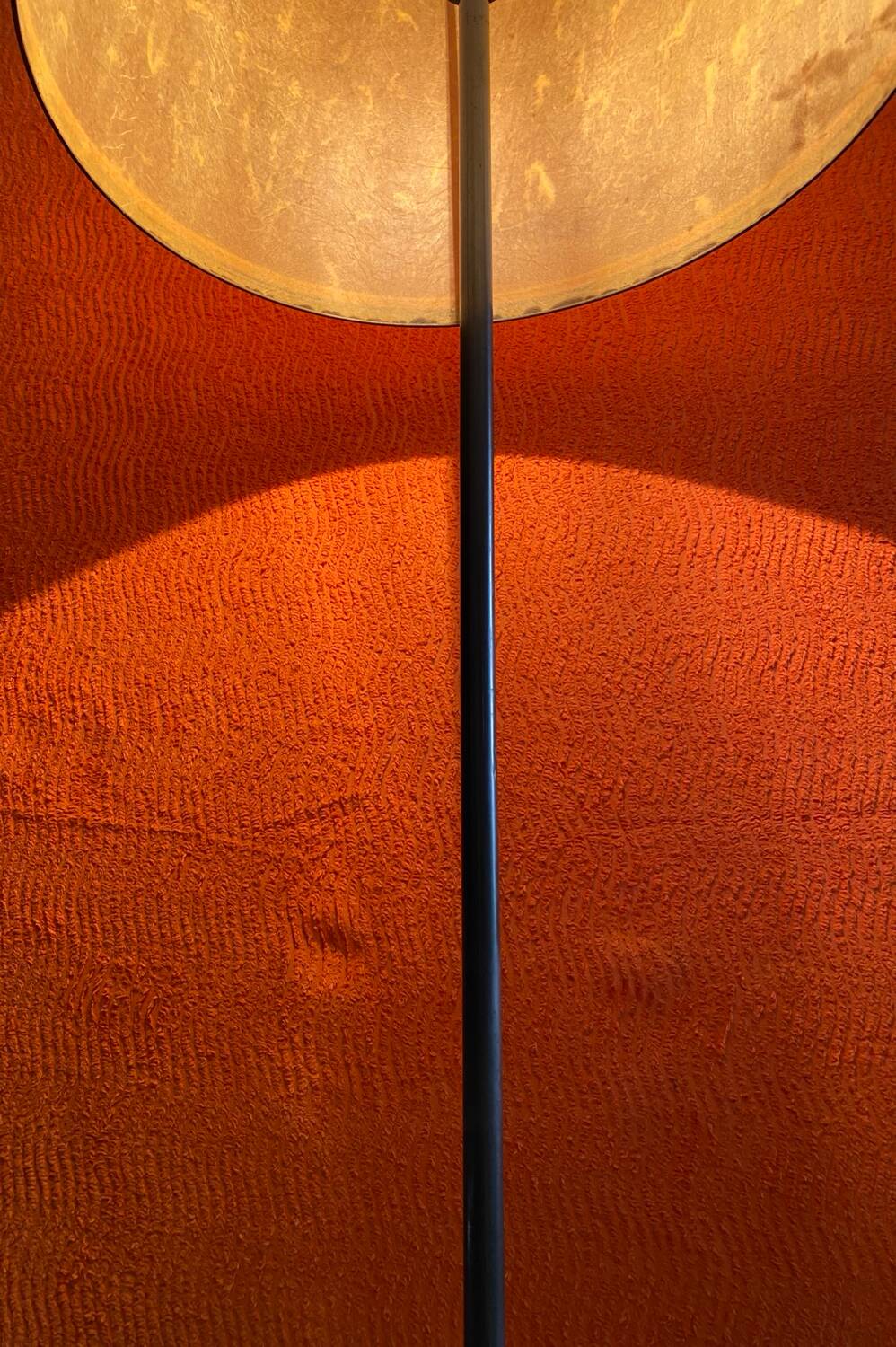 Vintage 1960s floor lamp with black tripod base and round varnished wooden shelf