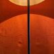 Vintage 1960s floor lamp with black tripod base and round varnished wooden shelf