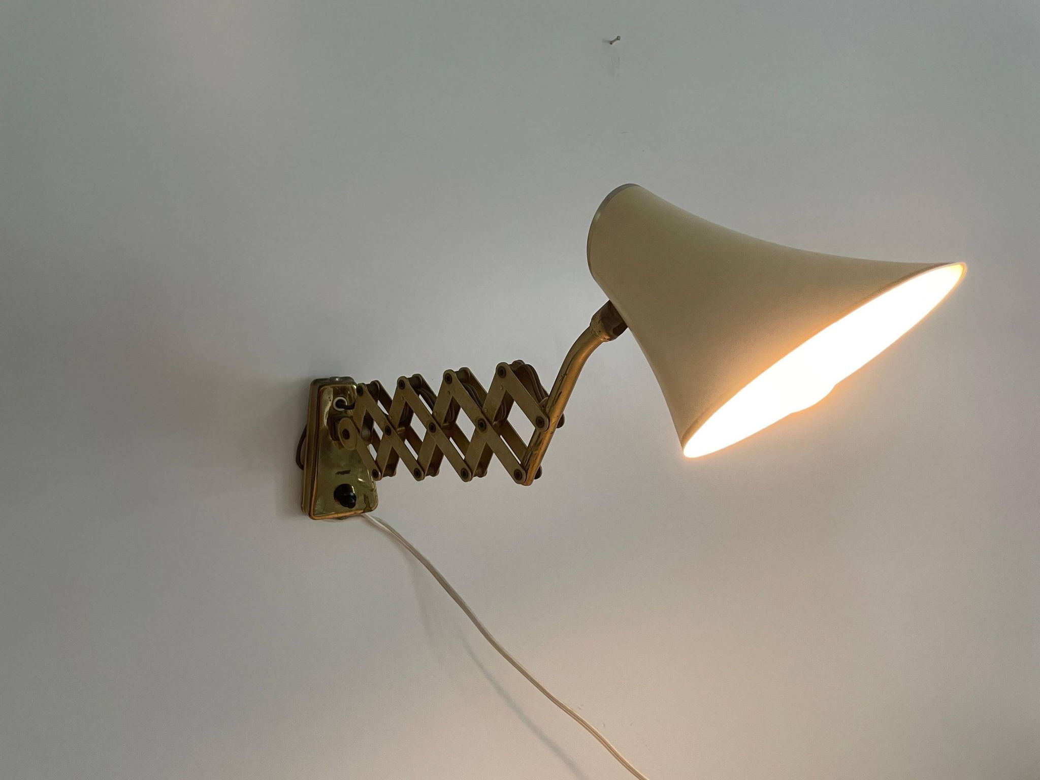Cream metal and brass wall lamp with scissors design by Karl Lang for SIS Licht, 1950s, Germany.