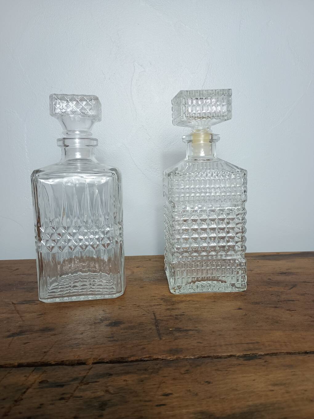 Mismatched pair of whisky decanters.