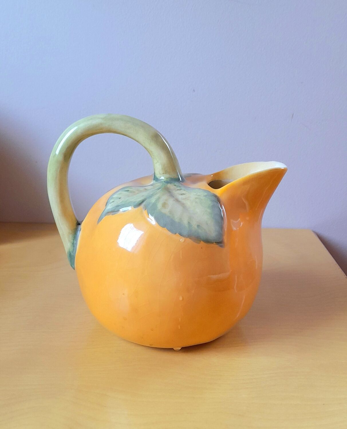 Orange pitcher in slip