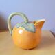 Orange pitcher in slip