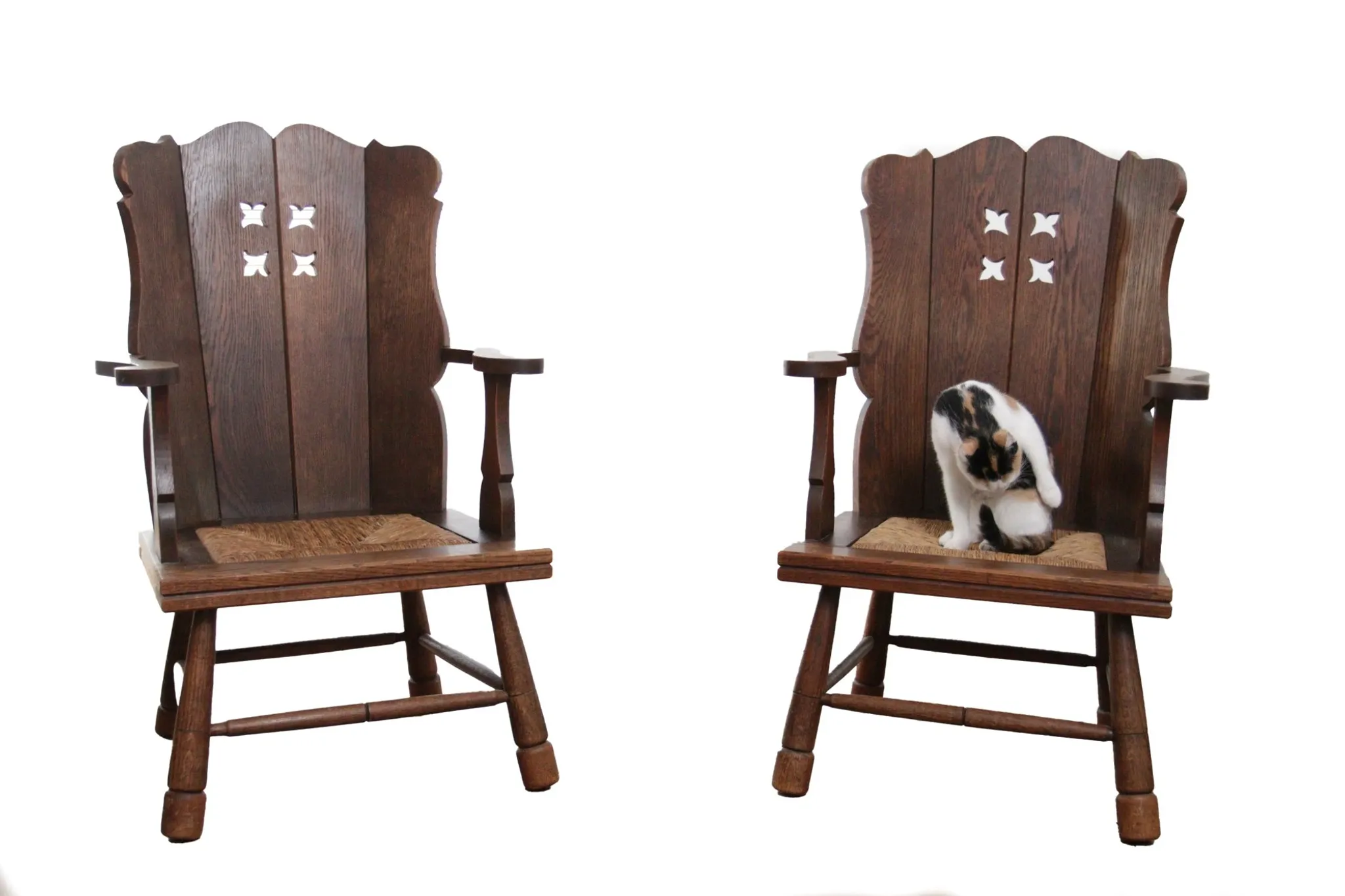 Pair of brutalist oak lounge chairs with rush seats, circa 1935