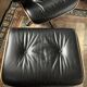 Black leather Eames Vitra armchair, original with rosewood ottoman.