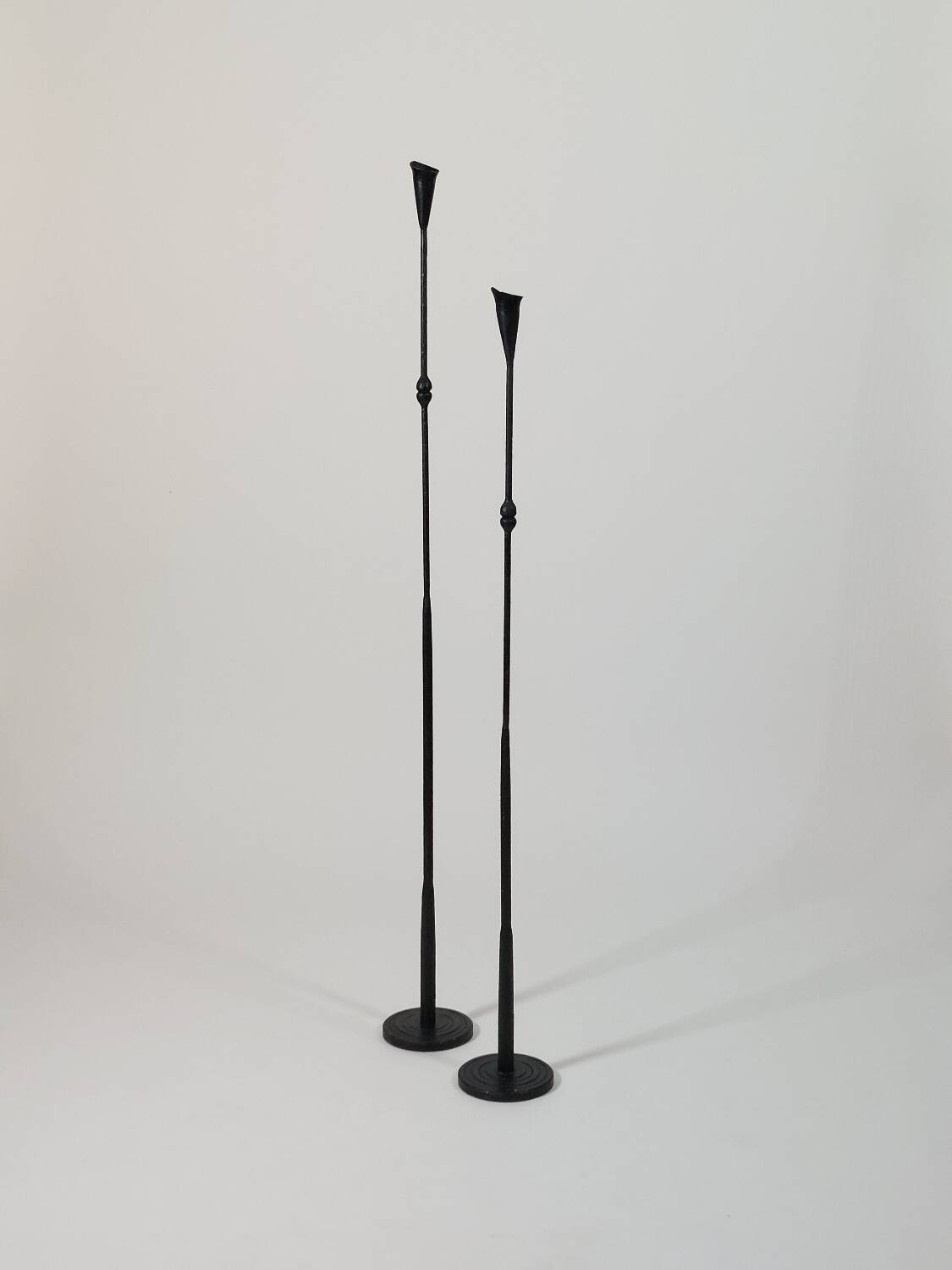 A pair of beautiful and exquisite vintage wrought iron candlesticks from the mid-century.
