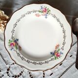 Old hollow plates mismatched in earthenware with gilded edges