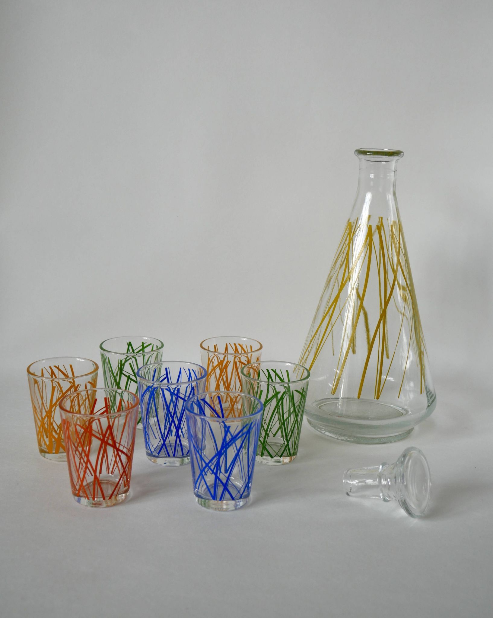 Colorful designer set composed of 7 liqueur glasses and a seventies 70s carafe