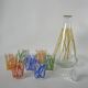 Colorful designer set composed of 7 liqueur glasses and a seventies 70s carafe