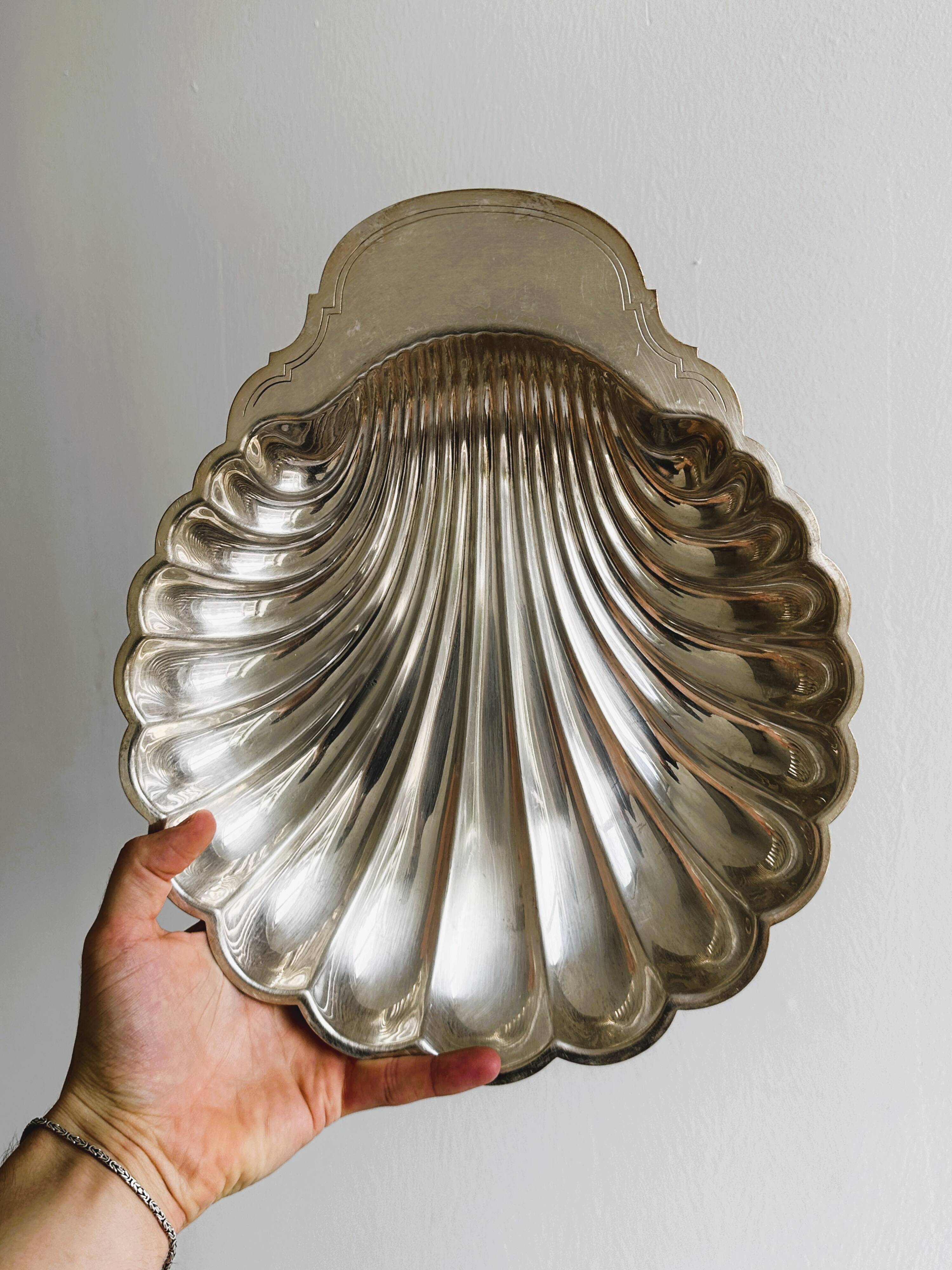 large silver-plated metal shell-shaped dish
