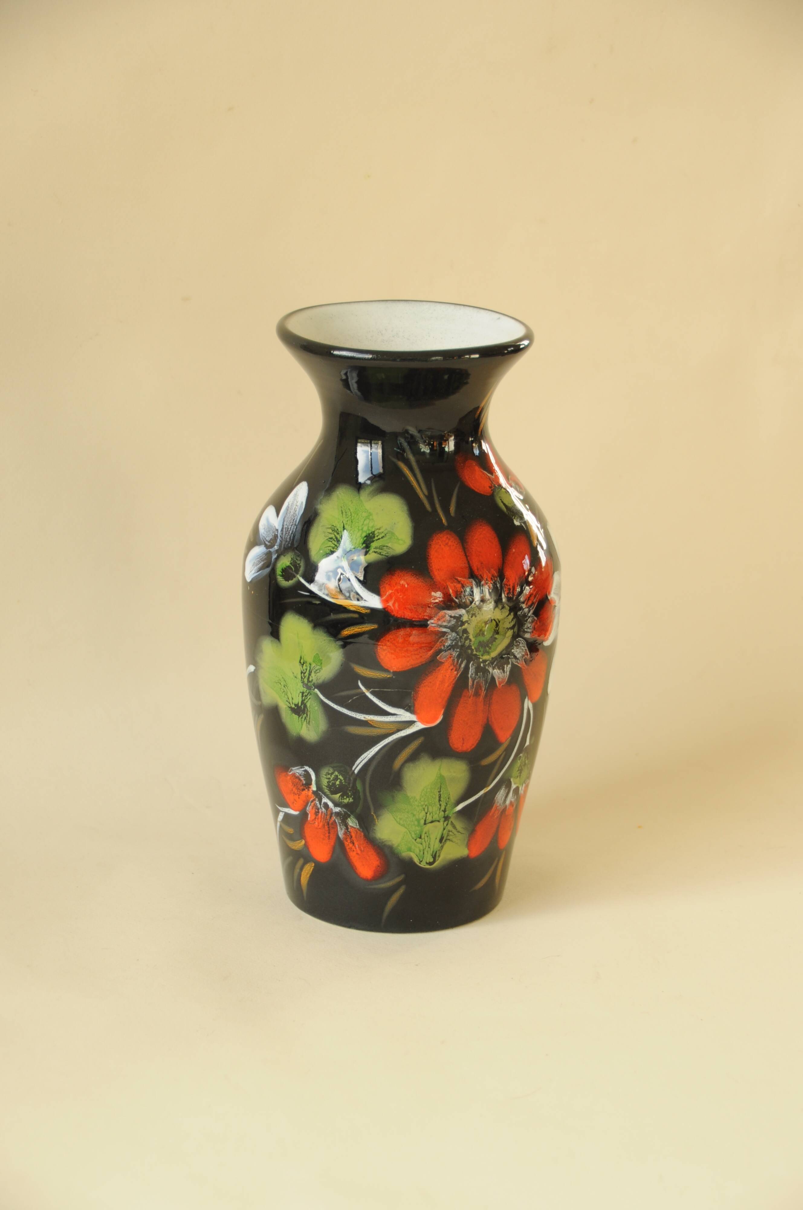 Vintage black ceramic vase with painted floral decoration – stylised colourful flowers.