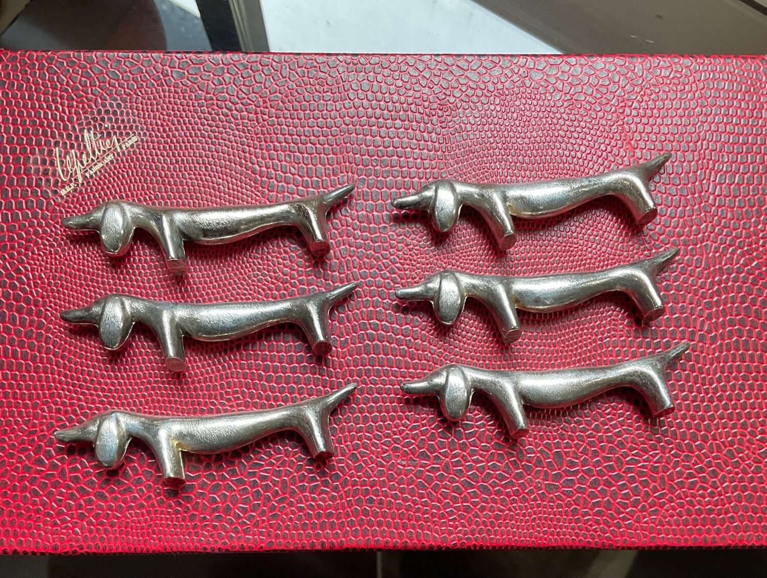 Series of vintage Dachshund knife holders in silver metal