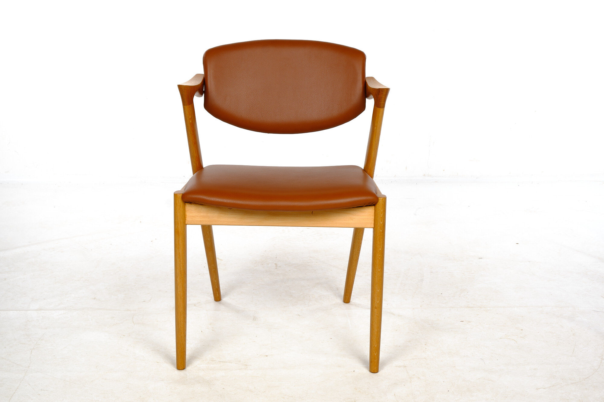 Four Kai Kristiansen oak chairs with new leather upholstery
