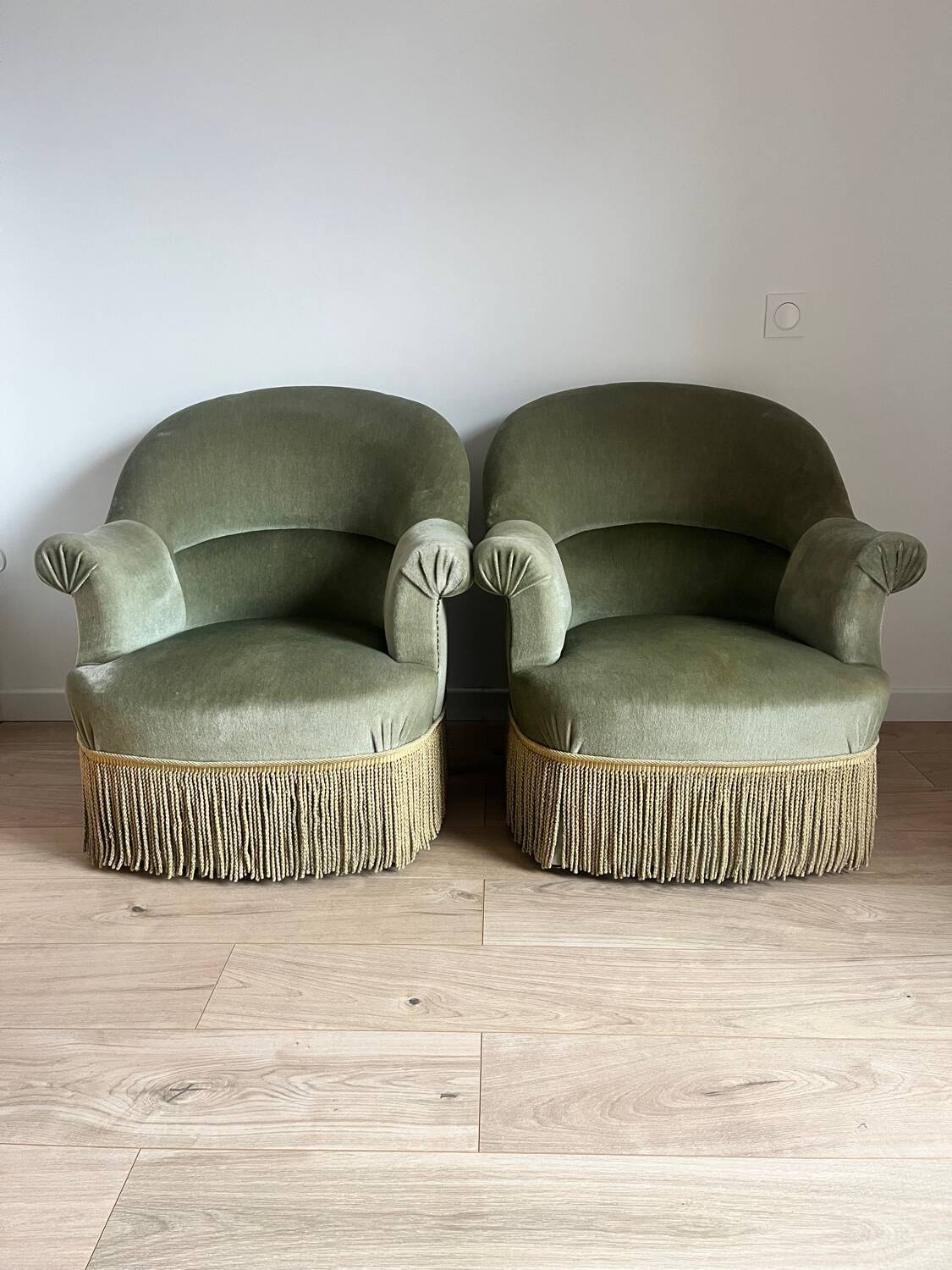 sage green toad armchairs with gold fringe