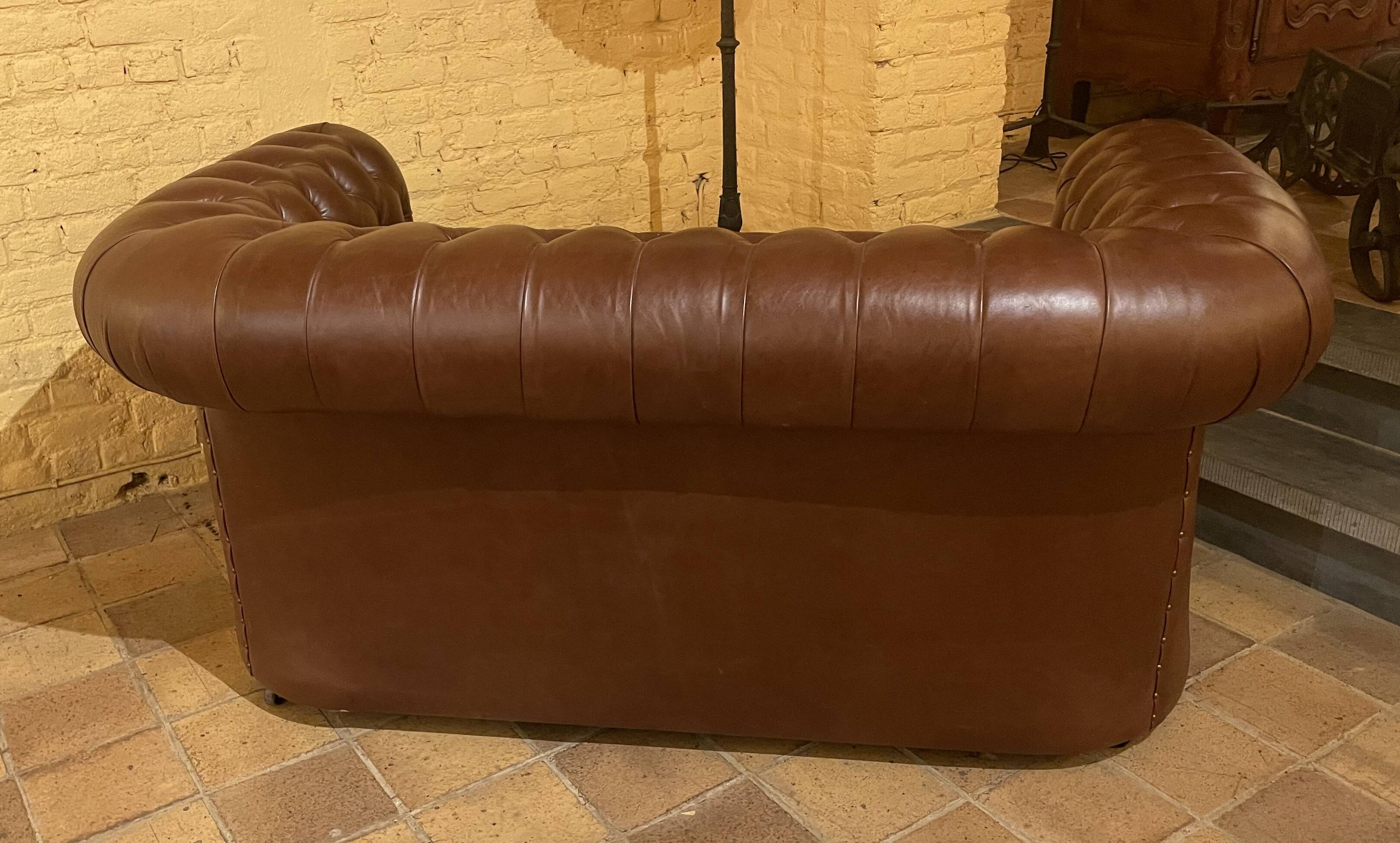 brown leather 2-seater Chesterfield sofa