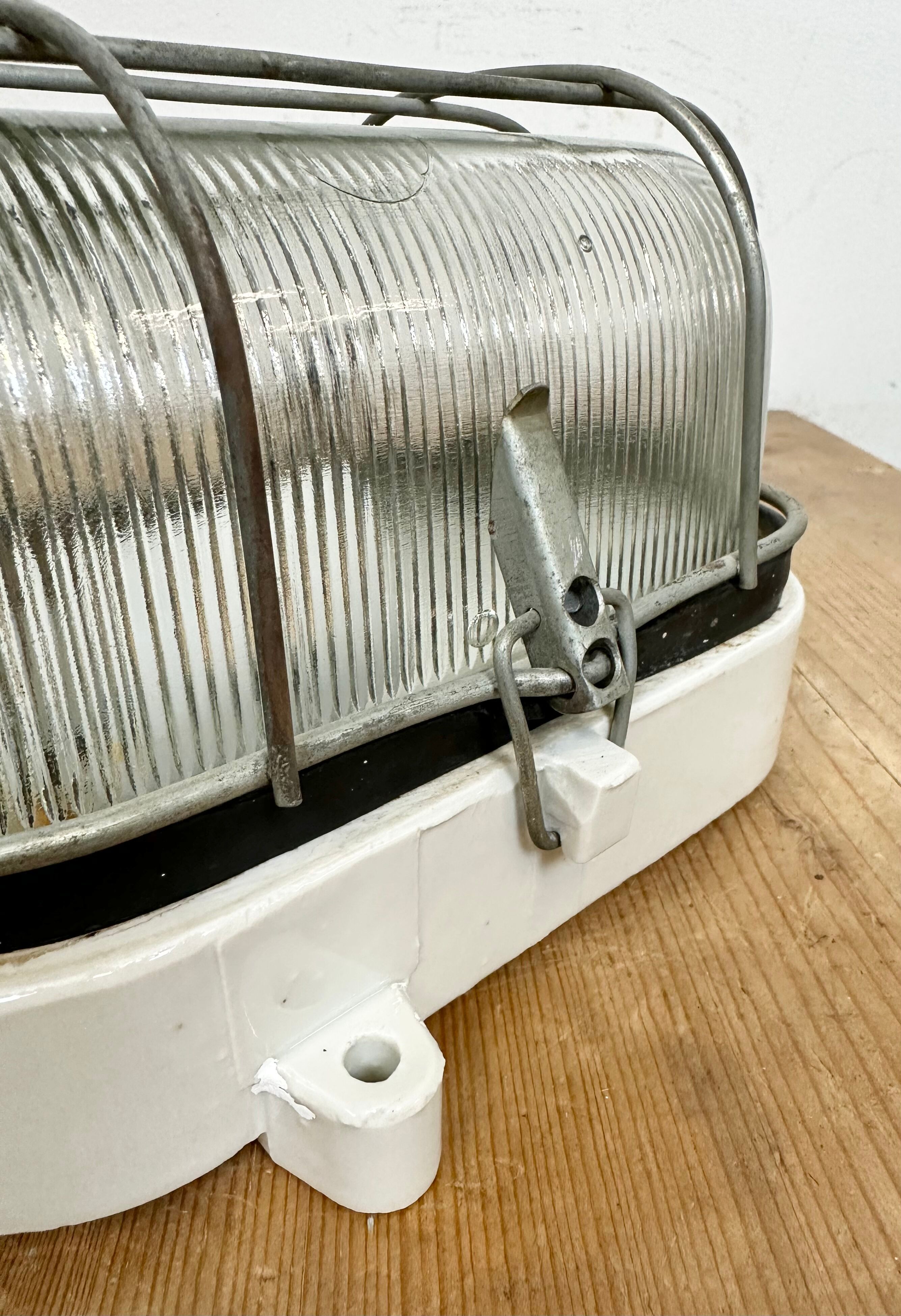 Industrial white porcelain cage wall light with ribbed glass, 1970s